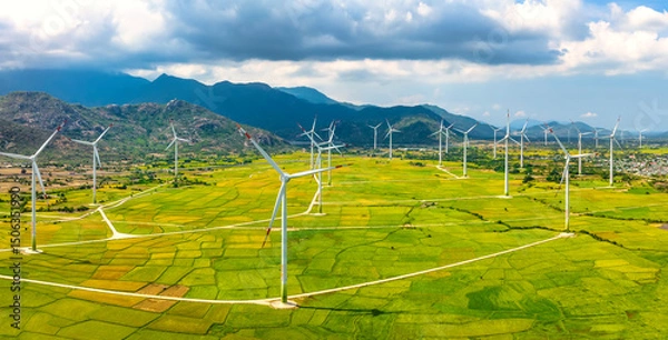 Obraz Panoramic view of wind farm or wind park. Wind turbines generating electricity on rice field at Phan Rang, Ninh Thuan, Vietnam. Clean energy concept