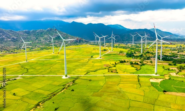 Obraz Panoramic view of wind farm or wind park. Wind turbines generating electricity on rice field at Phan Rang, Ninh Thuan, Vietnam. Clean energy concept