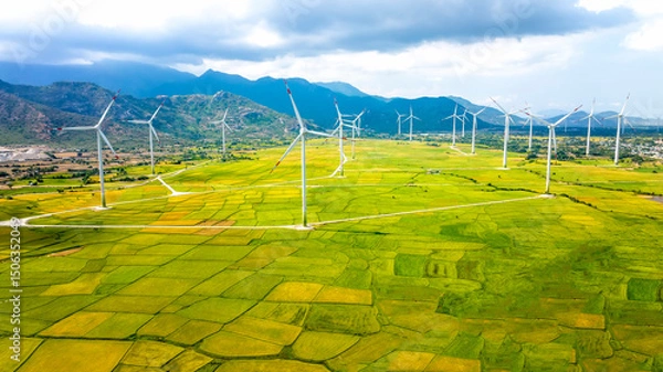 Obraz Panoramic view of wind farm or wind park. Wind turbines generating electricity on rice field at Phan Rang, Ninh Thuan, Vietnam. Clean energy concept