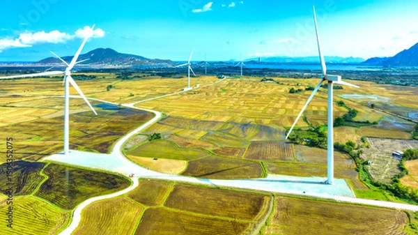 Obraz Panoramic view of wind farm or wind park. Wind turbines generating electricity on rice field at Phan Rang, Ninh Thuan, Vietnam. Clean energy concept