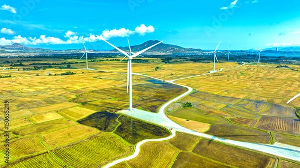 Obraz Panoramic view of wind farm or wind park. Wind turbines generating electricity on rice field at Phan Rang, Ninh Thuan, Vietnam. Clean energy concept