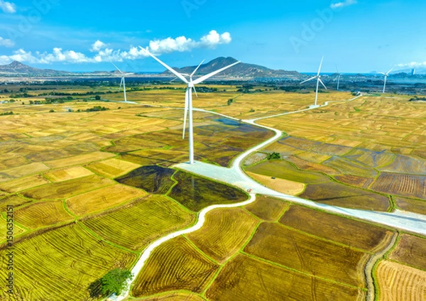 Obraz Panoramic view of wind farm or wind park. Wind turbines generating electricity on rice field at Phan Rang, Ninh Thuan, Vietnam. Clean energy concept