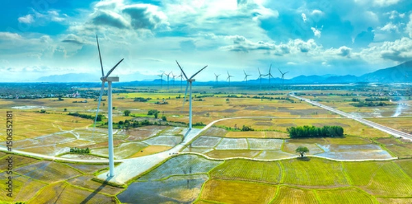 Obraz Panoramic view of wind farm or wind park. Wind turbines generating electricity on rice field at Phan Rang, Ninh Thuan, Vietnam. Clean energy concept