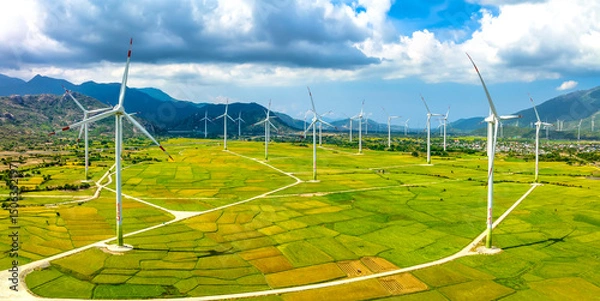 Obraz Panoramic view of wind farm or wind park. Wind turbines generating electricity on rice field at Phan Rang, Ninh Thuan, Vietnam. Clean energy concept