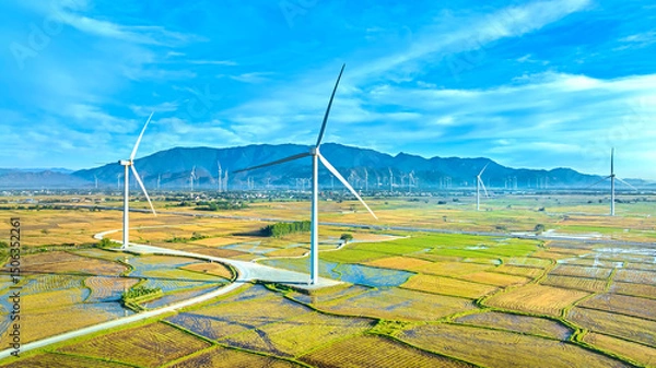 Obraz Panoramic view of wind farm or wind park. Wind turbines generating electricity on rice field at Phan Rang, Ninh Thuan, Vietnam. Clean energy concept