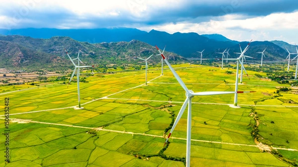 Obraz Panoramic view of wind farm or wind park. Wind turbines generating electricity on rice field at Phan Rang, Ninh Thuan, Vietnam. Clean energy concept