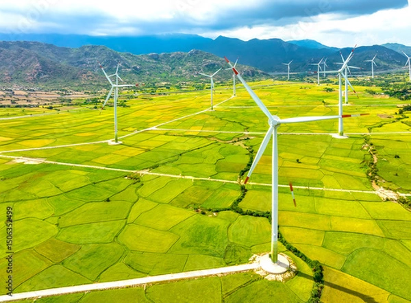 Obraz Panoramic view of wind farm or wind park. Wind turbines generating electricity on rice field at Phan Rang, Ninh Thuan, Vietnam. Clean energy concept