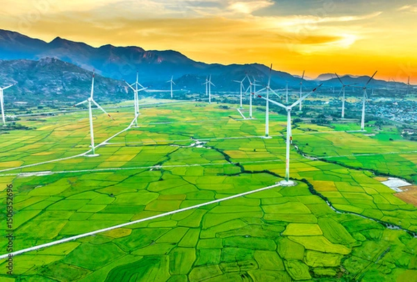 Obraz Panoramic view of wind farm or wind park. Wind turbines generating electricity on rice field at Phan Rang, Ninh Thuan, Vietnam. Clean energy concept
