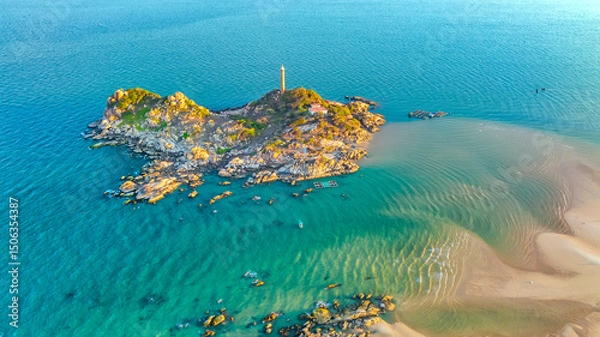 Obraz Landscape of small island with ancient lighthouse at sunrise sky is beautiful and peaceful. This is only ancient lighthouse is located on island in Vietnam