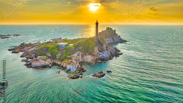 Obraz Landscape of small island with ancient lighthouse at sunrise sky is beautiful and peaceful. This is only ancient lighthouse is located on island in Vietnam