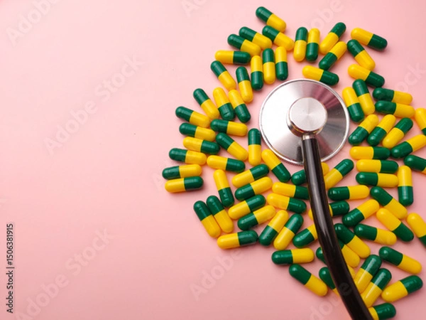 Fototapeta Top view statehoscope and medicine pill on a pink background with copy and text space