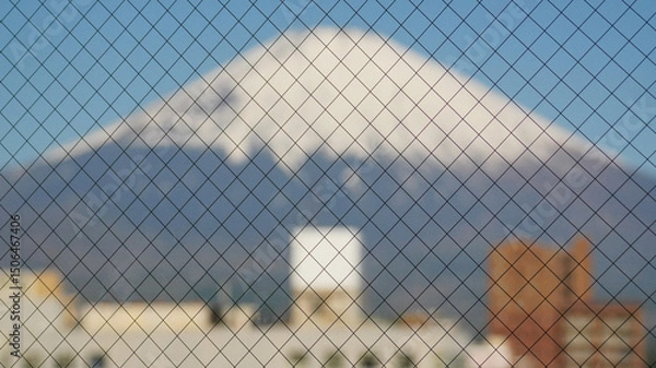 Fototapeta Snow-covered mountains fuji appear in the distance, blurring behind the wire-reinforced front window.