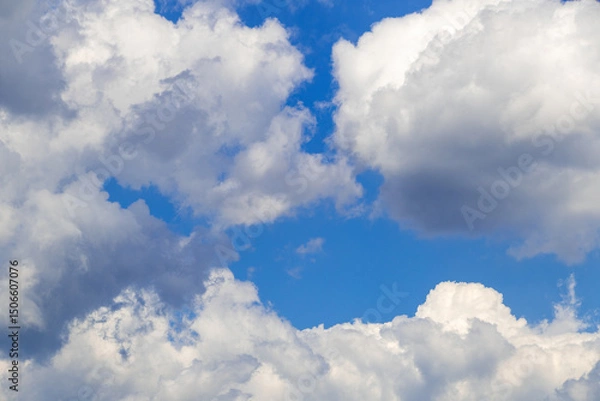 Obraz Bright blue sky with fluffy white clouds on a sunny day