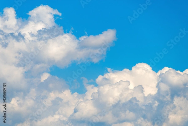 Obraz Bright blue sky with fluffy white clouds on a sunny day
