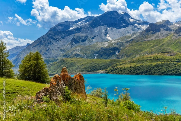Fototapeta Picturesque view of a turquoise water of Mont Cenis lake surrounded by green slopes and mountains in France.