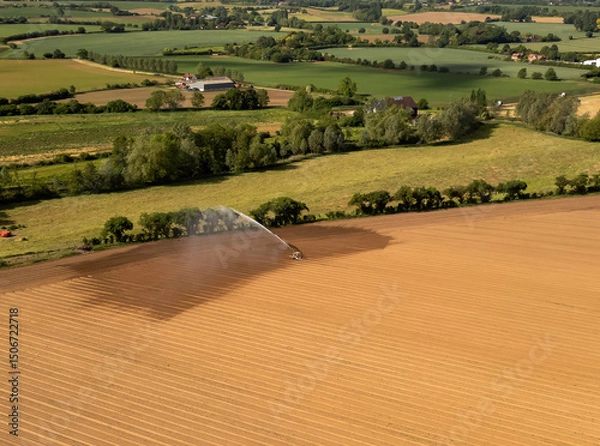Fototapeta An aerial view of farmland being irrigated near Bures in Suffolk, UK