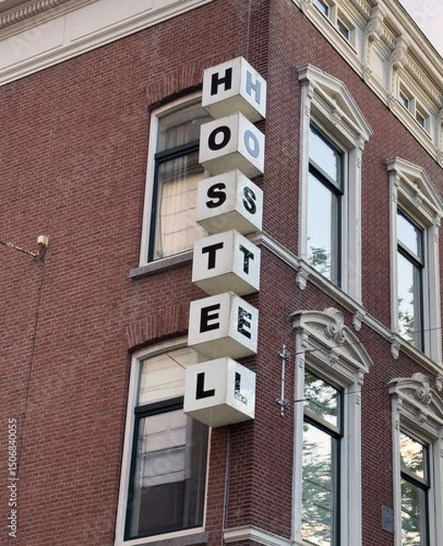 Obraz Hostel sign on brick wall building facade, Netherlands, Holland. Travel and accomodation