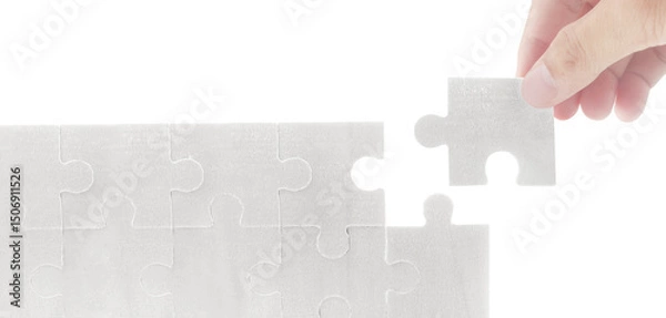 Fototapeta Completing a puzzle piece indoor setting visual content minimalist environment close-up view problem solving concept