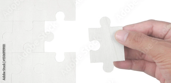 Fototapeta Placing final puzzle piece indoor table photo series minimalist environment close-up view puzzle concept