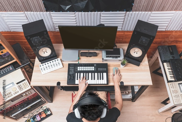 Obraz top view of asian male music producer, composer, arranger, musician composing a song in home recording studio. music production concept