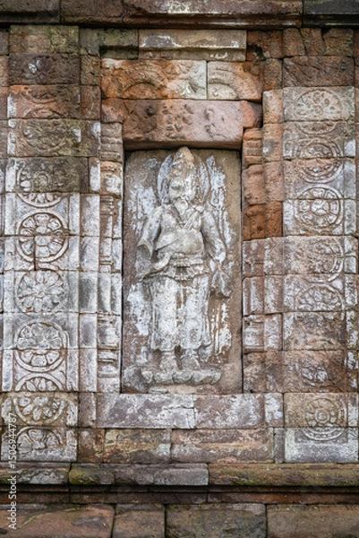 Obraz Vertical view of Indian sage Agastya on exterior of ancient hindu Gedong Songo III temple wall, Bandungan, Semarang, Java, Indonesia