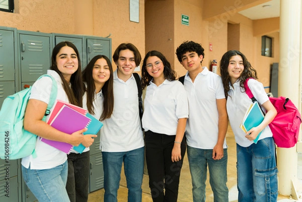 Obraz Group of high school students wearing uniform posing by lockers