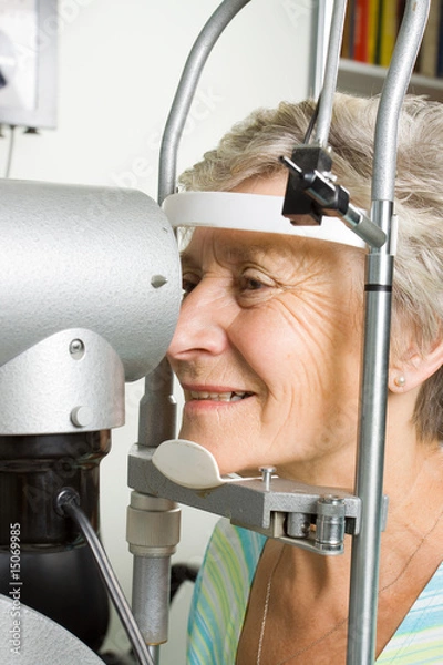 Obraz Lady having eye test examination