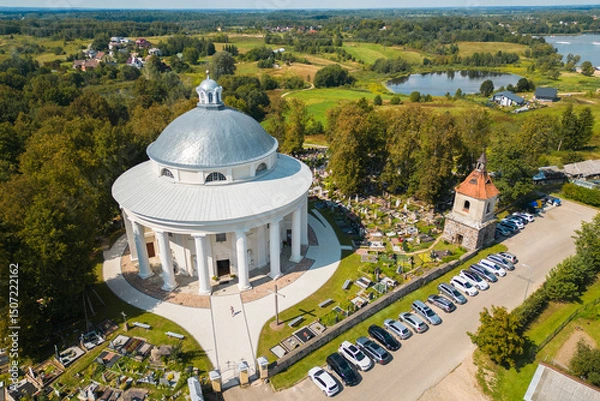 Fototapeta Aerial View of Round Church of the Holy Trinity Building Surrounded by Cemetery in Suderve Town Near Vilnius