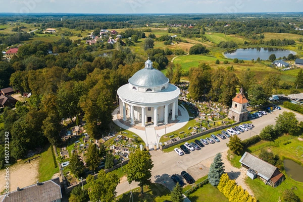 Fototapeta Aerial View of Round Church of the Holy Trinity Building Surrounded by Cemetery in Suderve Town Near Vilnius
