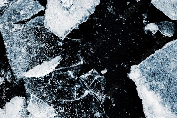 Fototapeta Broken textured ice. Crushed natural textured ice on a black background, close-up.