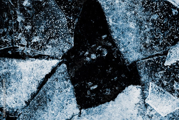 Fototapeta Broken textured ice. Crushed natural textured ice on a black background, close-up.