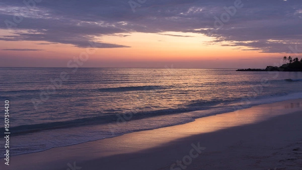 Fototapeta Serene coastal scene captured during sunset with beach, ocean, and pastel sky.