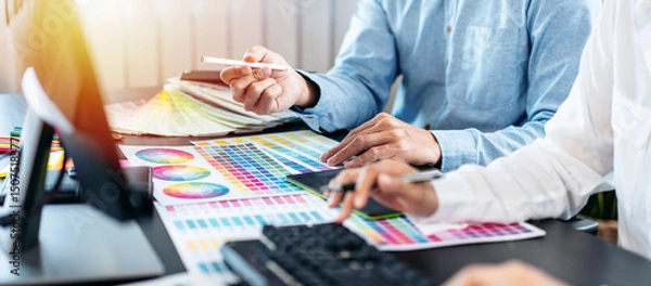 Obraz Team of creative graphic designer working on color swatch samples chart for selection coloring in inspiration to create new collection at workplace