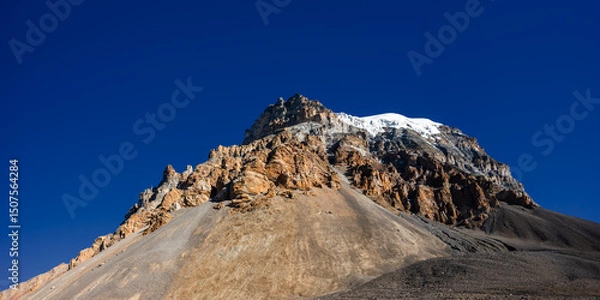 Obraz Panoramic view of the Yakwakang peak summit against blue sky. View  from the descent from Thorung La to Muktinath. Annapurna circuit trek, Himalaya mountains, Nepal.