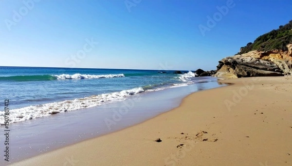 Fototapeta Serene Seashore with Gentle Waves and Clear Blue Sky