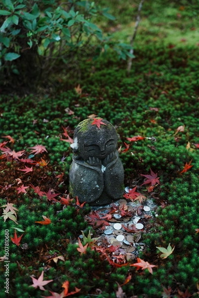 Fototapeta Smiling Jizo Statue with Autumn Maple Leaves in a Moss Garden at Kyoto
