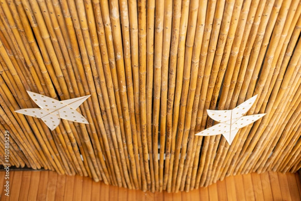Fototapeta The bamboo ceiling is decorated with kites.