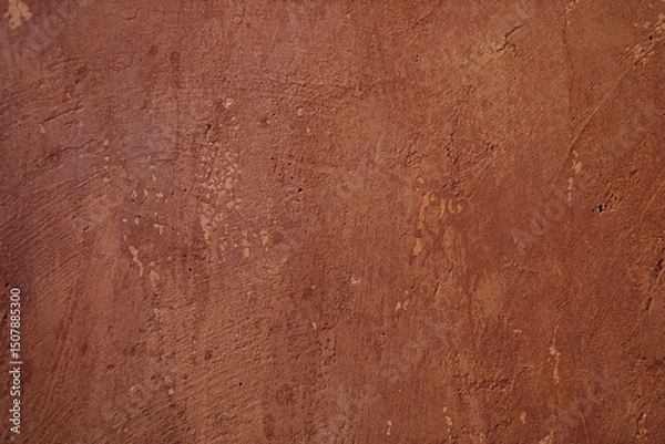 Fototapeta The cement surface is unevenly plastered and painted in dark brown.