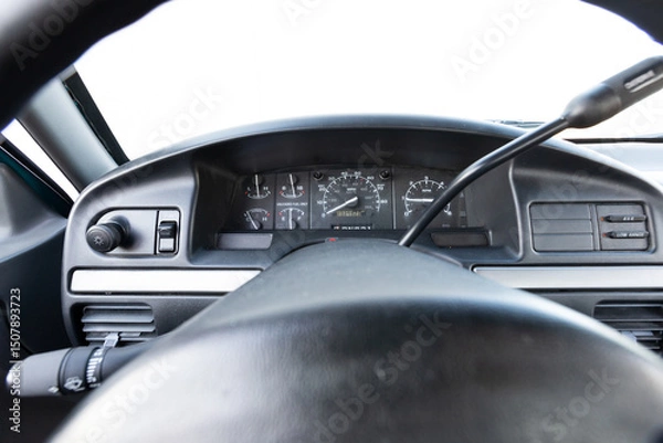 Obraz Close-up dashboard details of an older American pickup truck with 4x4 drivetrain. Features include control knobs, radio unit, climate panel, and gauges, all photographed in clean daylight conditions