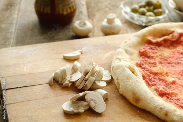 Fototapeta Making pizza with cremini. Sliced mushrooms for pizza on table