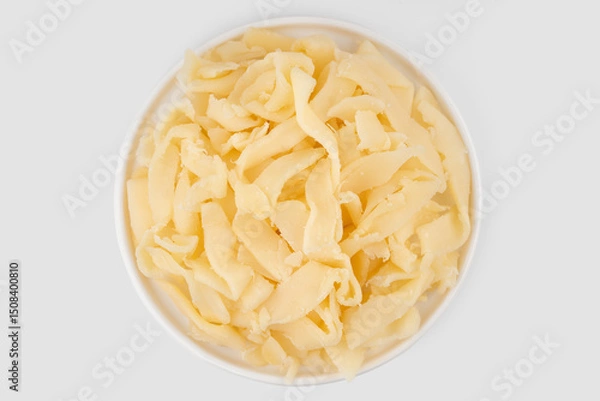 Fototapeta Beer snack made of dried squid. Dried squid isolated on white background. Dried squid shavings. Small fish, shrimp and squid that have been marinated with salt and dried