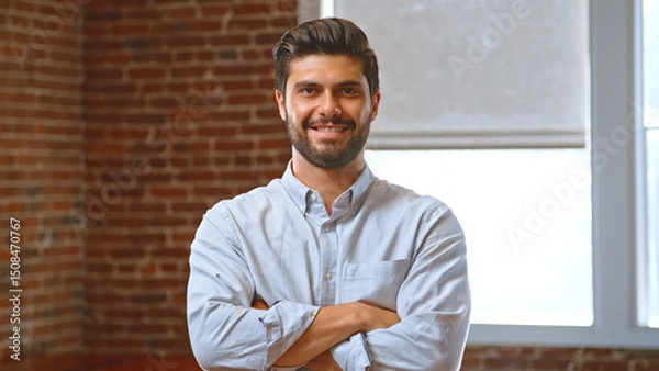 Obraz Portrait Of Smiling Businessman In Office Standing By Window