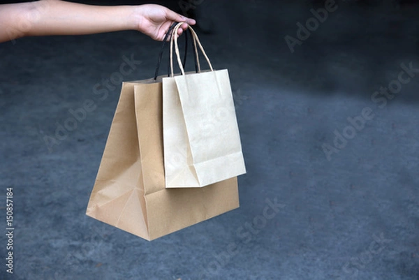 Fototapeta Recycled brown paper shopping bags in my hand
