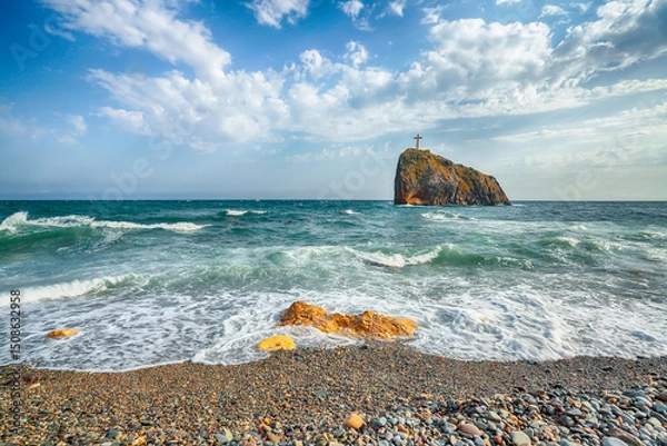 Fototapeta Amazing view of sea waves crashing on the shore and flowing above seashore pebbles.