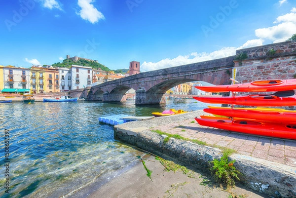 Fototapeta Attractive cityscape of Bosa town with Ponte Vecchio bridge across the Temo river.
