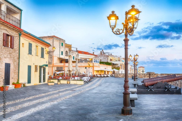 Fototapeta Amazing evening cityscape of historical part of Alghero town.