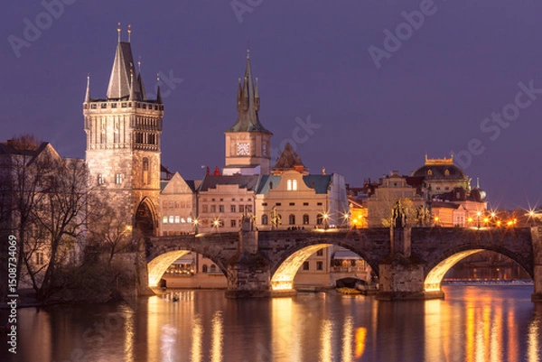 Fototapeta Illuminated Charles Bridge over the Vltava River at sunset in Prague Czech Republic