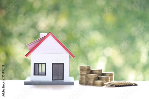 Obraz Mortgage,Model house and stack of coins money on natural green background,Business investment and real estate concept