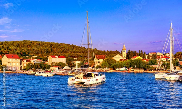 Fototapeta Zlarin island , Croatia, Sibenik archipelago: Sunset view of the waterfront with boats in the port, Dalmatia, coral jewellery island