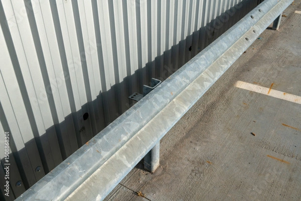 Fototapeta guard rail is a safety barrier that prevents vehicles from leaving the roadway in the event of an accident, its robust structure reflects a combination of efficient engineering and attention to detail